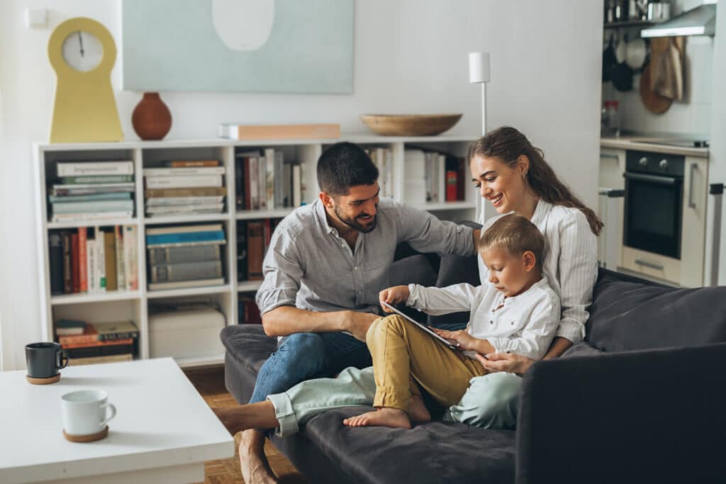 happy family spending time together using tablet computer at home